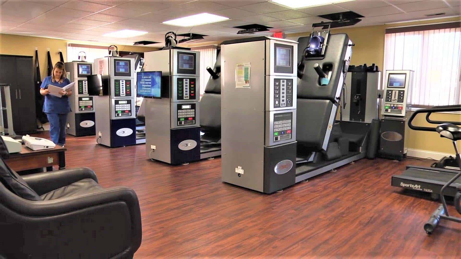 A gym room with treadmills and exercise machines.